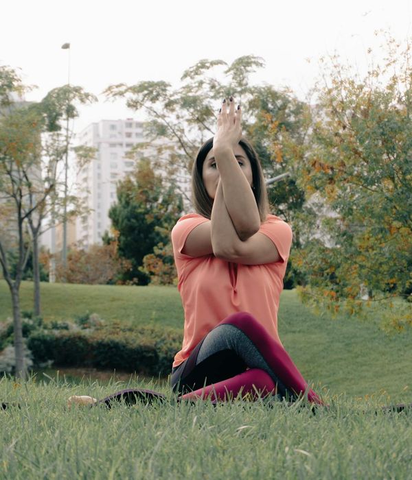 Woman in a calm yoga pose, embodying harmony and balance.